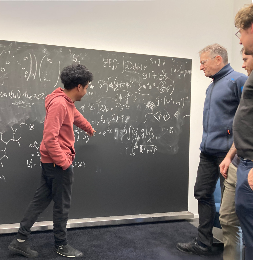 Image of people next to a blackboard